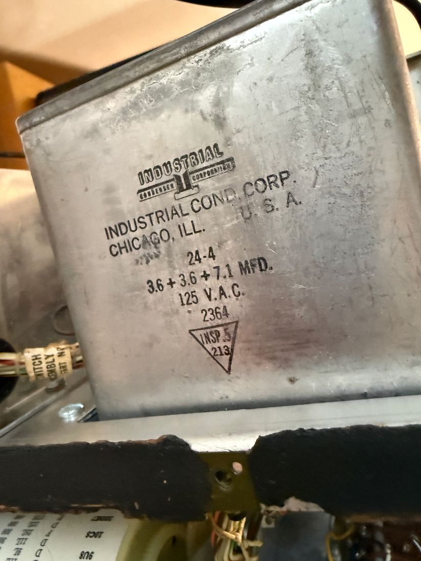 A rectangular metal can capacitor stamped Industrial Condenser Corp., Chicago, 3.6 plus 3.6 plus 7.1 MFD, 125 VAC.