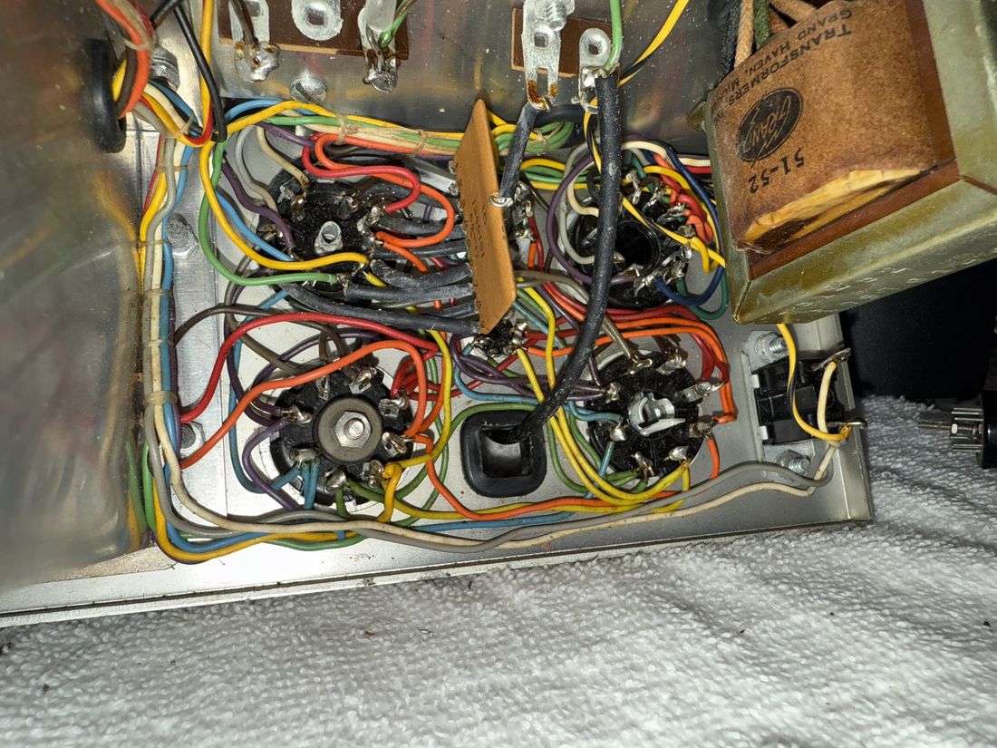 The underside of the TT-1 chassis: a dense field of cloth-covered wires in many colors, tube sockets, and old components.